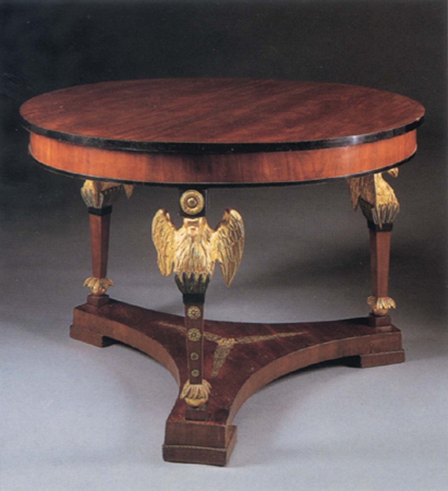 19th Century AUSTRIAN ,   Neoclassical Mahogany and Parcel Gilt Center Table  ,  1800-1825  
  Mixed woods ,  29 x 43 x 43 in. (73.7 x 109.2 x 109.2 cm)  
  Circular top with an ebonized border above the plain frieze, raised on winged eagle terminal supports joined by a tripartite stretcher with later ormolu decoration, all on block feet.  
  AUS-001-FU  
   Appraisal Value : $0.00 
 Location : $0.00 
 User3 : $0.00